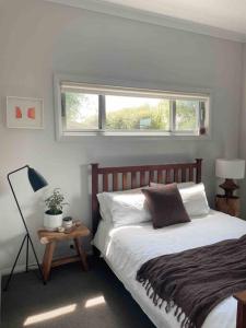 a bedroom with a large bed and a window at Gerringong Bliss in Gerringong