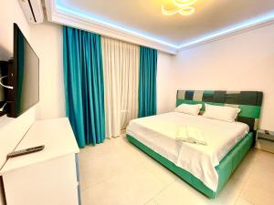 a hotel room with a bed and a television at Marcony Summerland Apartments in Mamaia