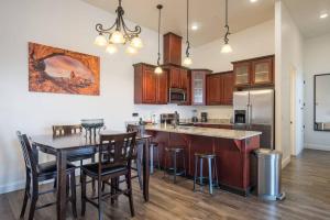a kitchen with a table and chairs and a refrigerator at Luxury Downtown Rental - La Dolce Vita Villa #3 in Moab