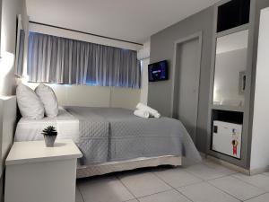Łóżko lub łóżka w pokoju w obiekcie Hotel Oscar Gold Savassi
