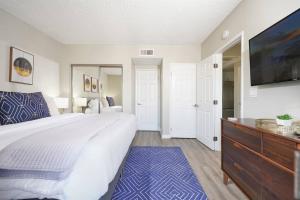 um quarto com uma cama grande e uma televisão de ecrã plano em Mid Century Style / King Bed / Disneyland / Nurses em Santa Ana