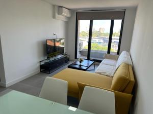 a living room with a couch and a television at View 3 in Punta del Este