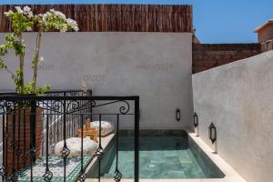 a swimming pool in the side of a building at Riad Kasbah El Mamoune in Marrakech