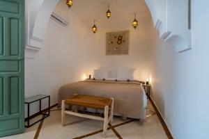 a bedroom with a bed and a green door at Riad Kasbah El Mamoune in Marrakech