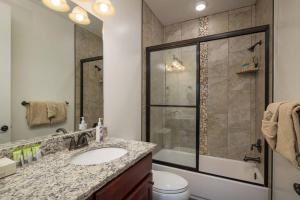 a bathroom with a shower and a sink and a toilet at Luxury Downtown Rental - La Dolce Vita Villa #4 in Moab