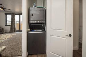 een woonkamer met een tv en een koelkast bij Luxury Downtown Rental - La Dolce Vita Villa #4 in Moab
