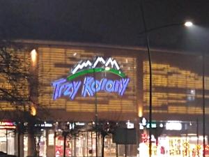 a neon sign on the side of a building at Trzy Korony Apartament in Nowy Sącz