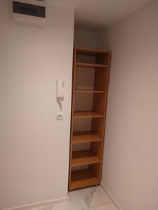 a book shelf in a room with a wall at Trzy Korony Apartament in Nowy Sącz