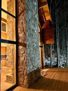 an open door of a house with a stone wall at Villa Noari, Brezovice. in Brezovica