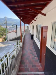 a walkway outside of a building with a balcony at Hotel Santorini in San Gil
