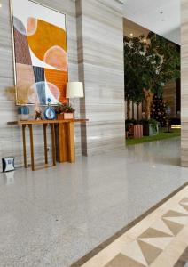 a lobby with a table and a painting on the wall at 38 Park Avenue condominium, IT Park in Cebu City