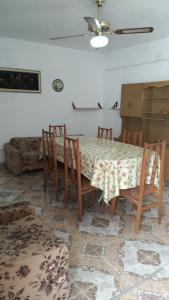 a dining room with a table and chairs and a couch at CasaTribuno in Salta