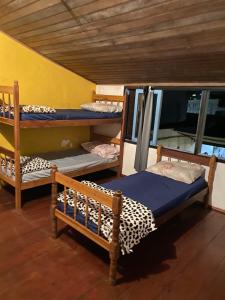 a bedroom with two bunk beds in a room at Casa Lee Hostel in Paraty +11 photos