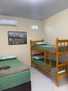 a room with two bunk beds in a room at Pousada Ferreira 415 in São Gabriel