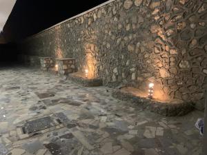 a stone wall with two benches with candles on it at Alfayrouz house in Hurghada