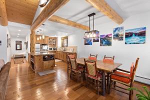 a kitchen and dining room with a wooden table and chairs at Rocky Point # 14 Palisades Townhome - Ski Shuttle w Tennis! in Olympic Valley