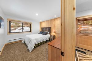 a bedroom with a bed and a window at Rocky Point # 14 Palisades Townhome - Ski Shuttle w Tennis! in Olympic Valley