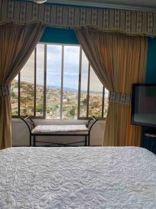 1 dormitorio con cama y ventana grande en AMPLIA CASA CON VISTA HERMOSA A TODA LA BAHIA en Viña del Mar