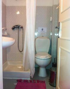 a bathroom with a toilet and a sink and a shower at Philippos Apartments in Acharavi