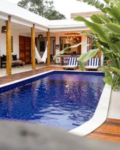 a swimming pool in a villa with a resort at CASA SIMONI Trancoso in Trancoso