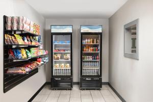 two refrigerators in a store with food and drinks at Garner Hotel Auburn - Seattle, an IHG Hotel in Auburn