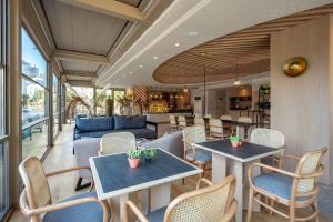 a restaurant with tables and chairs and a couch at Oli Hotel and Suites in Antalya