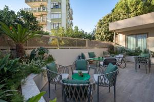 a patio with tables and chairs on a balcony at Oli Hotel and Suites in Antalya