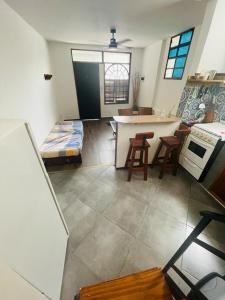 Mini house con sol y luz في بوينس آيرس: مطبخ مع طاولة وكراسي في غرفة