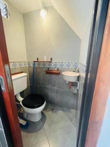 a small bathroom with a toilet and a sink at Mini house con sol y luz in Buenos Aires