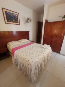 um quarto com uma cama e uma cabeceira em madeira em Hotel ESPLENDOR em Chiclayo