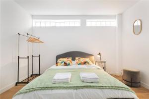 a bedroom with a large bed with two towels on it at Studio Cosy Paris/CDG/Expo/Stade in Aulnay-sous-Bois