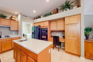 a kitchen with wooden cabinets and a counter top at SunnyBrook in Sun Lakes