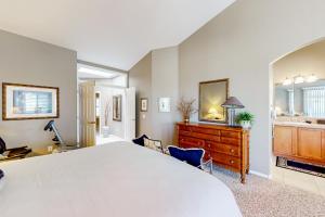 a bedroom with a large bed and a dresser at SunnyBrook in Sun Lakes +24 photos
