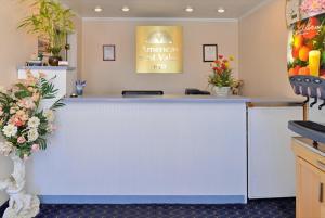 a white counter in a room with flowers on the wall at Americas Best Value Inn & Suites Klamath Falls in Klamath Falls