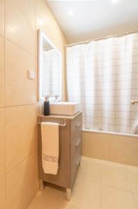 a bathroom with a sink and a mirror at Serene Haven Retreat - Madeira Island in Caniço