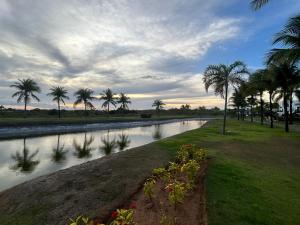 a river with palm trees on the side of it at Praia do Forte Iberostar in Praia do Forte