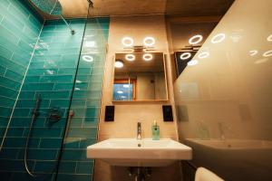 y baño con lavabo, ducha y espejo. en Traumferienhaus 2 mit Sauna und Bergblick en Garmisch-Partenkirchen