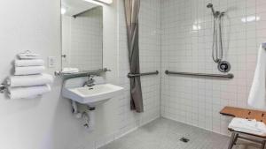 a white bathroom with a sink and a shower at Motel 6-Fremont, CA - South in Fremont +21 photos
