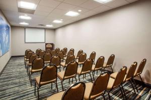 a conference room with chairs and a whiteboard at Wingate By Wyndham - Orlando International Airport in Orlando