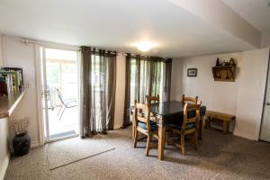 a dining room with a table and chairs and a window at Anchors Away in Leamington