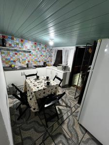 - une cuisine avec une table et des chaises dans la chambre dans l'établissement Minha casa, à Navegantes