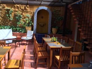 a restaurant with wooden tables and chairs and a door at Casa Roces in Legazpi