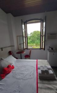 Cama ou camas em um quarto em Pousada Siroba BEIRA RIO