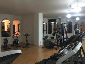 a gym with several treadmills and elliptical machines at Meson de la Merced in Zacatecas