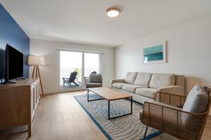 a living room with a couch and a tv at Hadley Resort and Marina in Islamorada