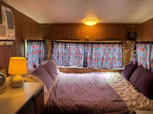 a living room with a couch and two windows at BERTHA caravan River Heads in River Heads