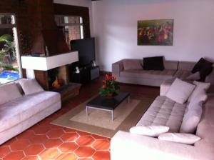 a living room with two couches and a fireplace at B&B Oui Madame in Tijuana
