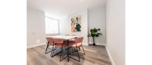 a dining room with a table and chairs at Hassle-Free & Handsome Brand-New 3-Bed Home in Manchester