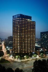 a tall building with a sign on the side of it at Shilla Stay Mapo Hongdae in Seoul