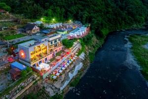 an aerial view of a hotel next to a river at Hongcheon Botopia Healing Park in Hongcheon